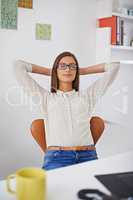 Time to sit back and relax. Shot of a young woman relaxing in her office.