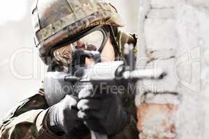 Hes a sharp shooter. Closeup of a soldier pointing his gun at the camera.