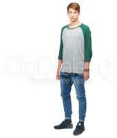 The road to fame and fortune starts here. A young teenage boy standing in a studio isolated on white.