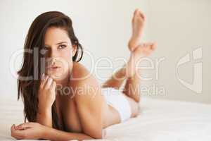 Flaunting her femininity. Shot of a beautiful woman posing nude.