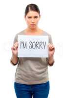 It wont happen again. A young woman holding a board with the words Im sorry.