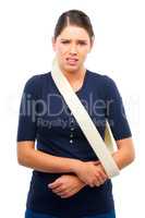 Ouch. Studio shot of a young woman with her arm in a sling isolated on white.