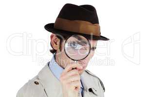 Ive got my eye on you. Curious private investigator looking through a magnifying glass against a white background.