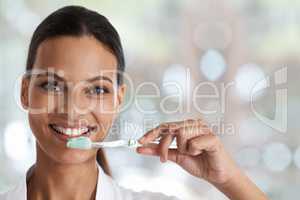 Brush everyday for a perfect smile. Portrait of a smiling woman holding a toothbrush.