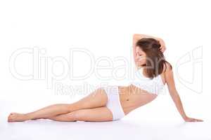She has confidence in her curves. Side view of a beautiful young woman in underwear lying on the floor.