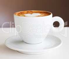 The only start to a morning. Shot of a freshly-made cappuccino on a white table.