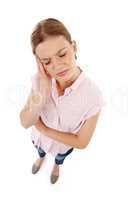 My head is killing me. High angle shot of an attractive young woman rubbing her head against a white background.