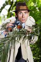 I cant believe that. Shocked private investigator using binoculars to spy on someone from the bushes.