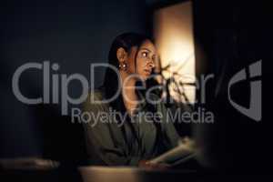 Focused on seeing it through to the end of the deadline. Shot of a young businesswoman working in an office at night.