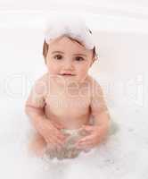 Playtime in the bath. Portrait of a cute baby girl in the bathtub.