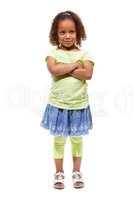 Shes got plenty of sass. Cute little african american girl standing against a white background with her arms folded.