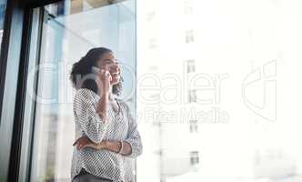 Shes established great connections with her clients. Shot of a young businesswoman talking on a cellphone in an office.
