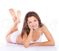 Shes naturally fit and beautiful. Full-length studio portrait of a young woman in underwear lying on the floor.