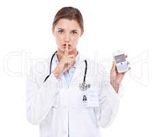 Doctor-client privelage. Portrait of an attractive young doctor telling you to be quiet while holding a cellphone.