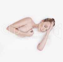 Smooth as silk. Studio shot of an attractive woman submerged in a white liquid.