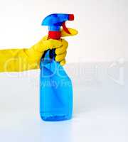 Spritz and clean. Cropped shot of a person spraying from a bottle of detergent against a grey background.