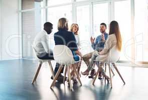 Putting their minds to work. Full length shot of a group of corporate colleagues meeting in their office.