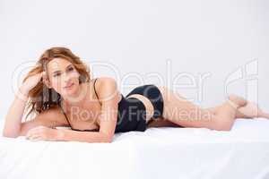 Making Lingerie look good. Portrait of a woman in lingerie lying down and posing seductively.