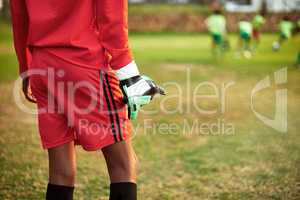 Ready to make his save. Closeup shot of a young boy standing as the goalkeeper while playing soccer on a sports field.