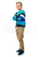 Hes a confident young boy. Full length portrait of a confident boy standing with his arms folded.