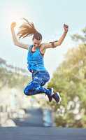 Hard work never goes unnoticed. Shot of a young woman jumping in mid air after her workout.