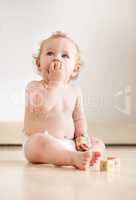 Filled with curiousity and wonder. Cute baby boy looking up curiously while sitting on the floor.