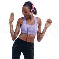 Moving to the beat. A woman in sportswear happily listening to music with her headphones.
