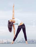 Rooftop fitness. An attractive young woman exercising on a rooftop.
