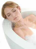 Gorgeous. A beautiful young woman closing her eyes and enjoying a luxurious bath.