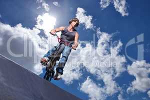 Practicing for the x games. Full length shot of a teenage boy riding a BMX at a skatepark.