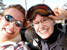 Winter vacations and recreation. A happy young couple about to go up a ski lift.