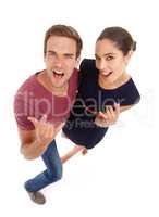 Vacation time - oh yeah. Full length studio shot of a young couple looking excited.