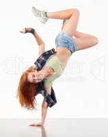 In the zone. Young woman doing hip hop dancing against a white background.