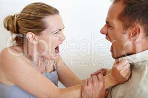 Id rather have loved and lost. Closeup of a wife grabbing her husbands shirt in anger as they fight.