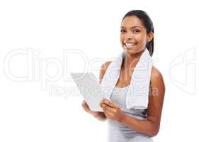 Using her tablet to monitor her fitness. A young woman in gym clothes working on a digital tablet.