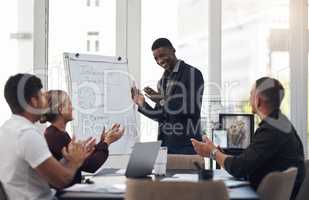 They dont just meet expectations, they exceed them. Shot of a group of businesspeople applauding during a presentation in an office.