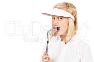 Golf can be so frustrating. Studio shot of an attractive female golfer biting down on her golf club in frustration isolated on white.