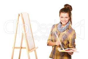 The creative juices are about to flow.... Studio shot of a young woman holding a palette and brush and standing with an easel.