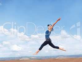 Leap if you love life. Shot of a beautiful young woman leaping enthusiastically during a workout outdoors.