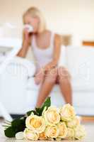 In Russia, Yellow roses are never a good sign. A young woman sneezing in the background with roses lying on the floor.