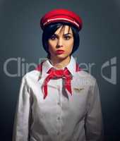 All aboard. Studio portrait of a woman dressed in a retro flight attendant uniform.