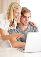 Open that link. A happy young couple using a laptop to surf the internet.