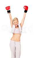 Shes a champion. Shot of a beautiful female boxer lifting her fist in to the air.