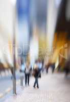 Motion blurred city life. Motion and lens blurred photo of city people.