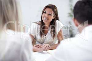 Taking her clients concerns into consideration. A pretty financial advisor listening to her clients intently.