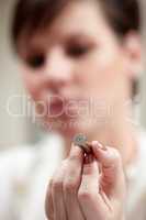 Checking out the evidence. Cropped closeup of forensic technician examining a bullet.