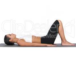 Breathing in deeply. A young woman doing stretches while isolated on white.