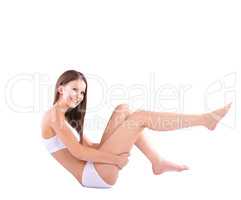 That is smooth.... Full body studio shot of a young woman caressing her bare leg.