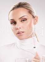 The beauty of a woman must be seen from in her eyes. Studio shot of young woman injecting herself with a potion against a white background.