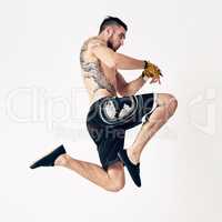 Float like a butterfly, sting like a bee. Studio shot of a young martial artist practicing.